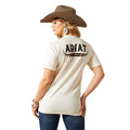 Woman wearing a cream-colored Ariat t-shirt with a brown cowboy hat on a white background