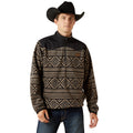 Man wearing a black and brown patterned pullover with a cowboy hat on a white background