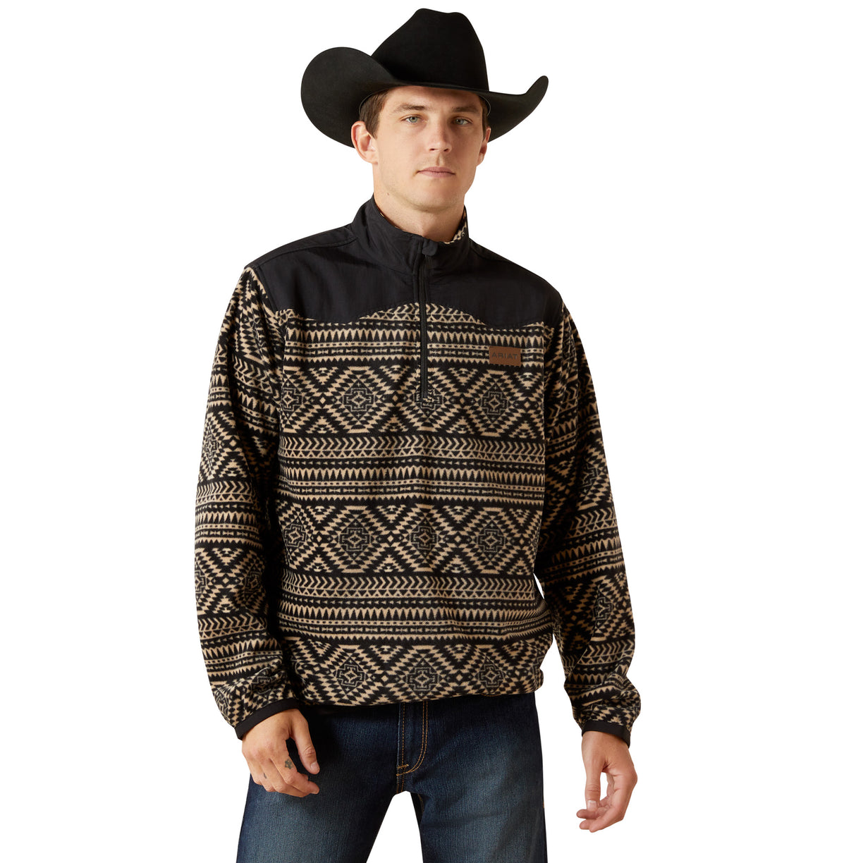 Man wearing a black and brown patterned pullover with a cowboy hat on a white background