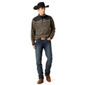 Man wearing a patterned shirt, jeans, and a cowboy hat on a white background