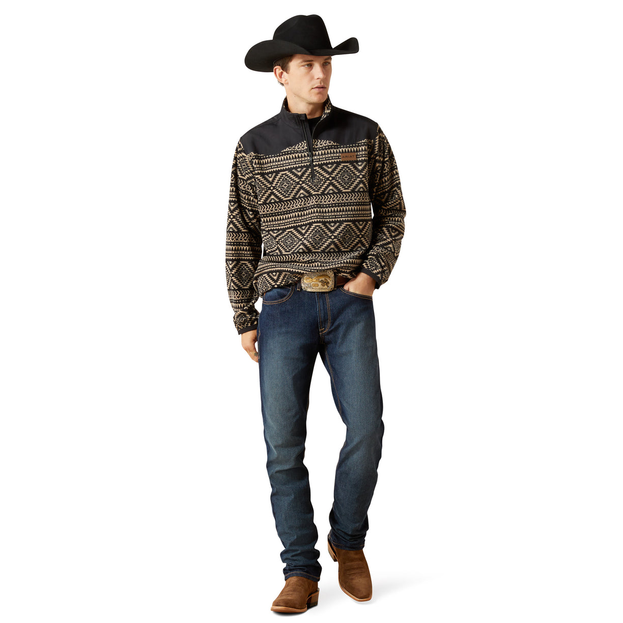 Man wearing a patterned shirt, jeans, and a cowboy hat on a white background