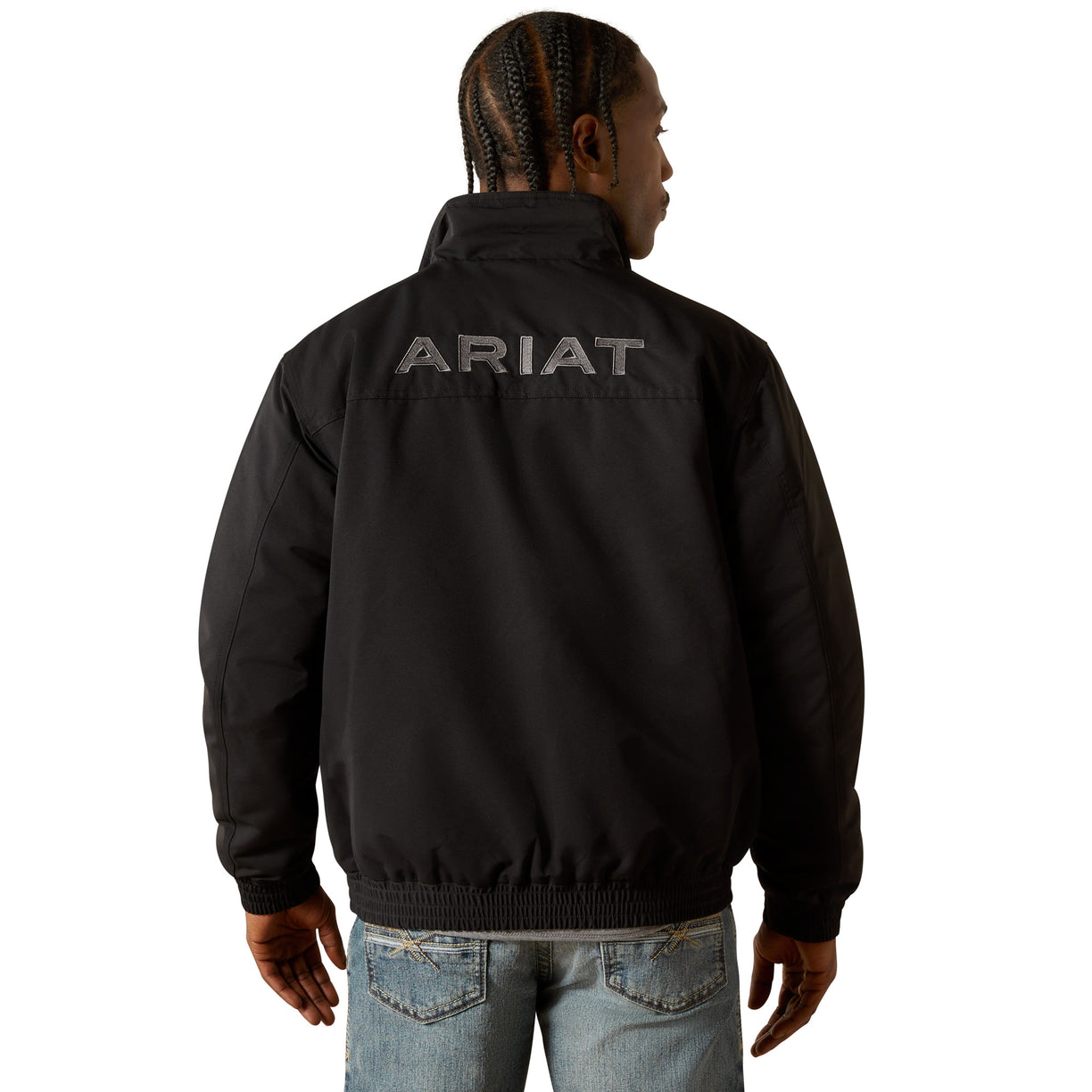 Person wearing a black Ariat jacket on a white background