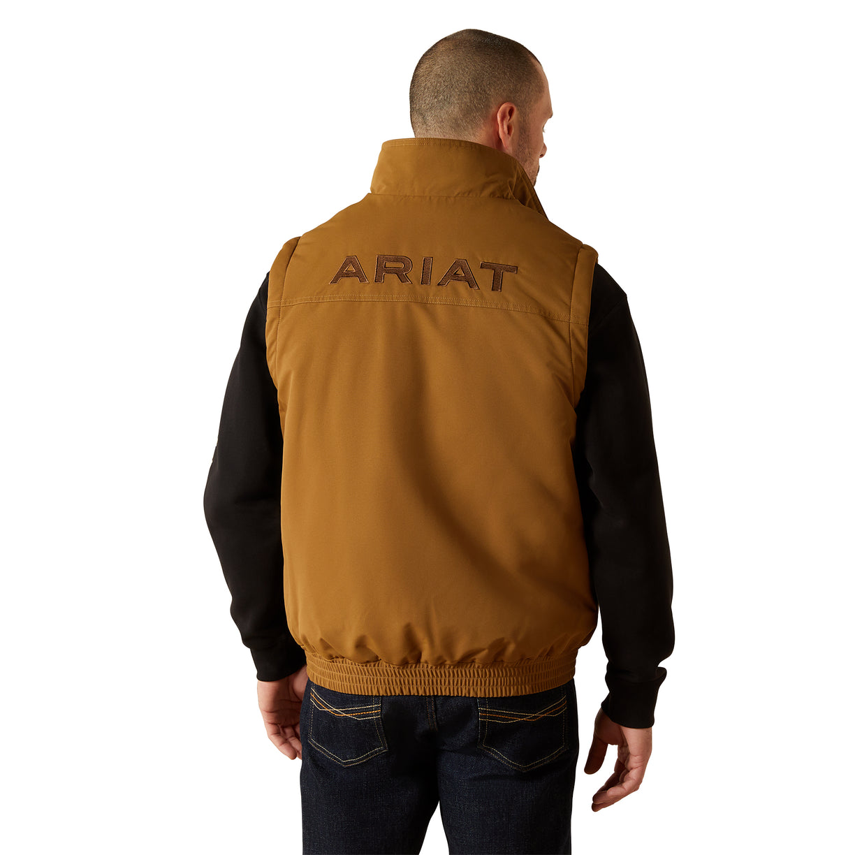 Man wearing a brown Ariat vest on a white background