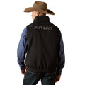 Man wearing a black Ariat vest with a white background