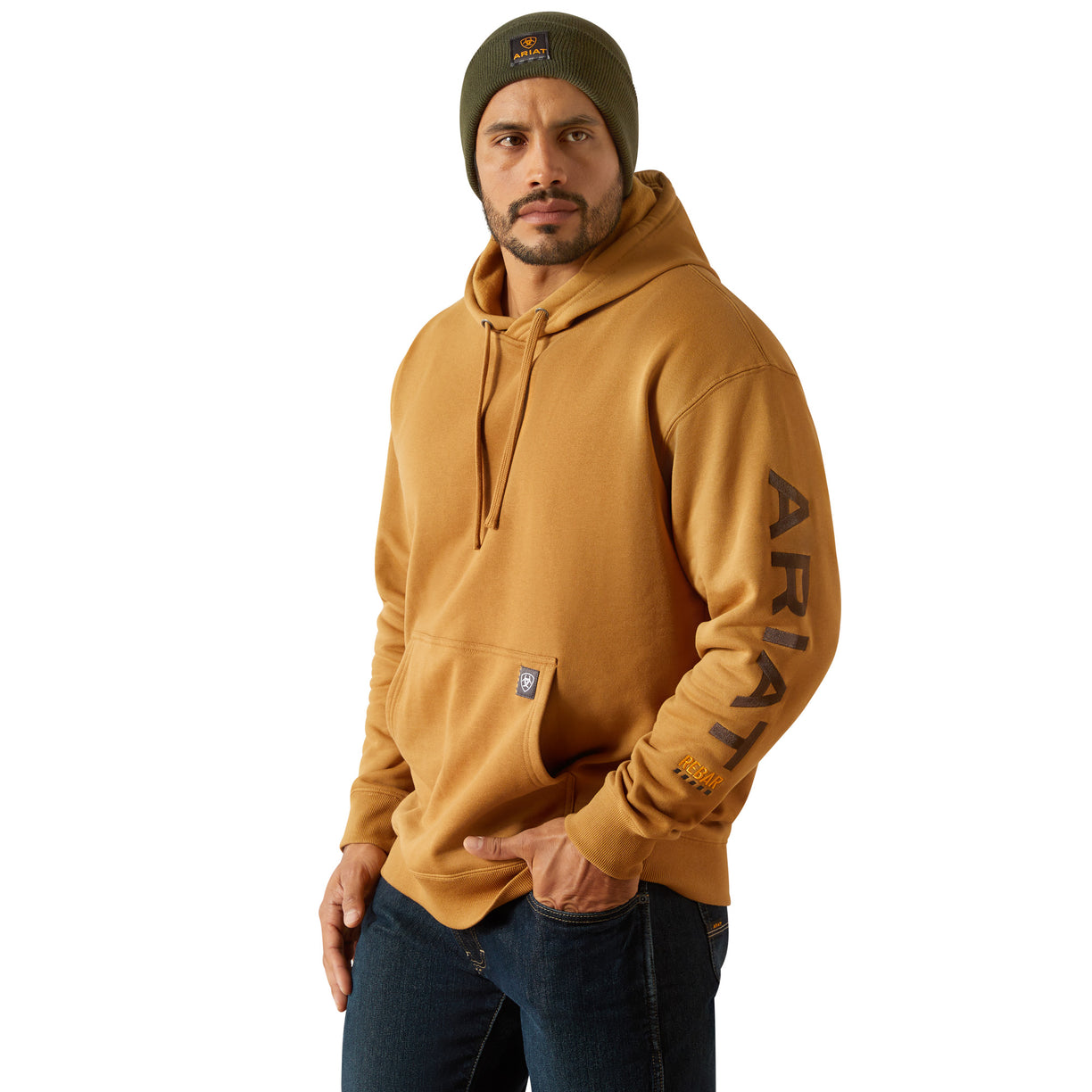 Man wearing a mustard yellow hoodie with 'Ariat' branding on a white background