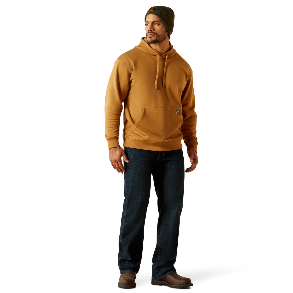 Man wearing a brown hoodie and dark jeans on a white background