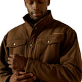 Man wearing a brown jacket with a brand logo on a white background