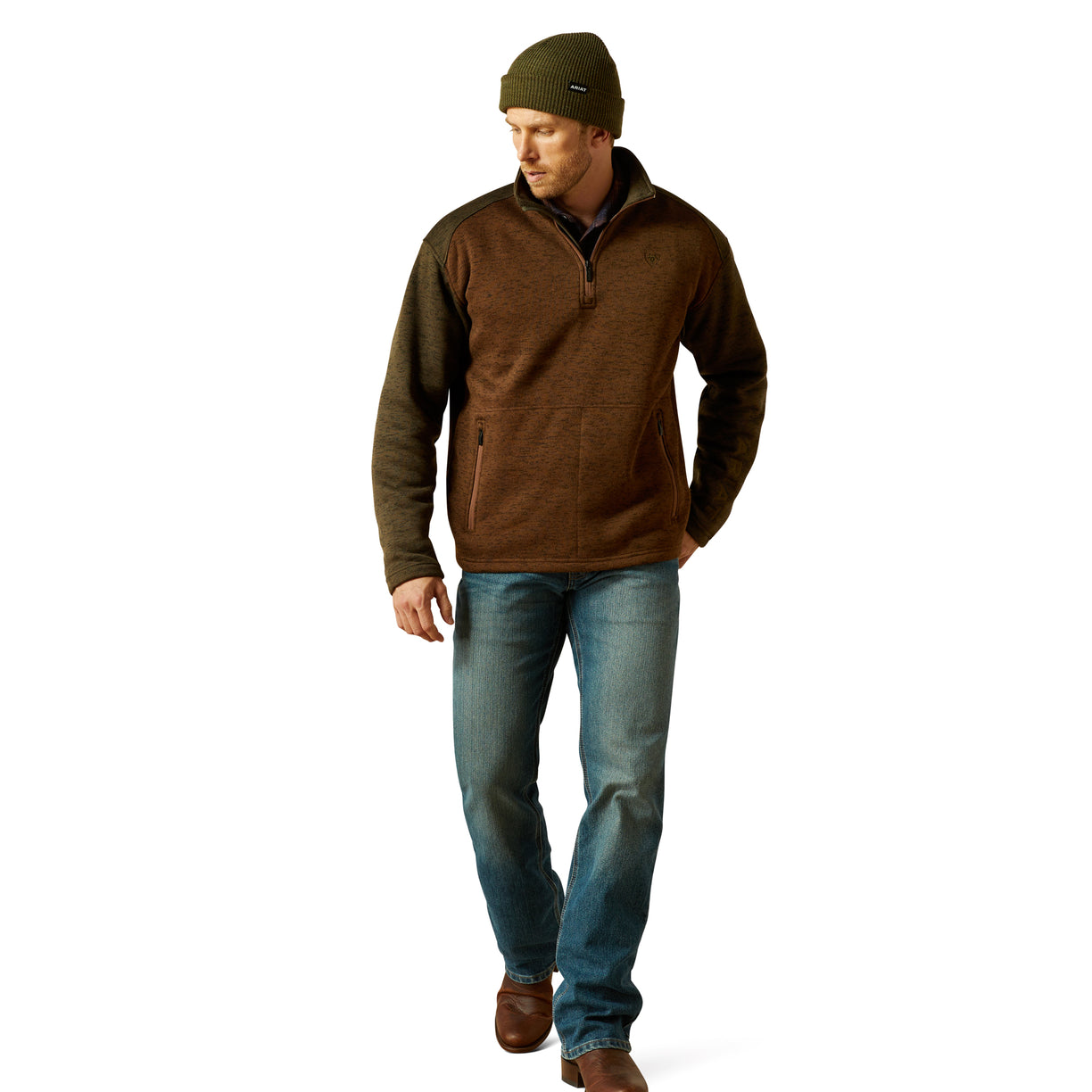 Man wearing a brown fleece pullover and blue jeans on a white background