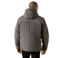 Person wearing a gray quilted jacket on a white background