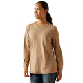 Woman wearing a beige long-sleeve shirt on a white background
