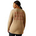 Person wearing a tan long-sleeve shirt with 'Ariat Work Est. 1999' text on the back.