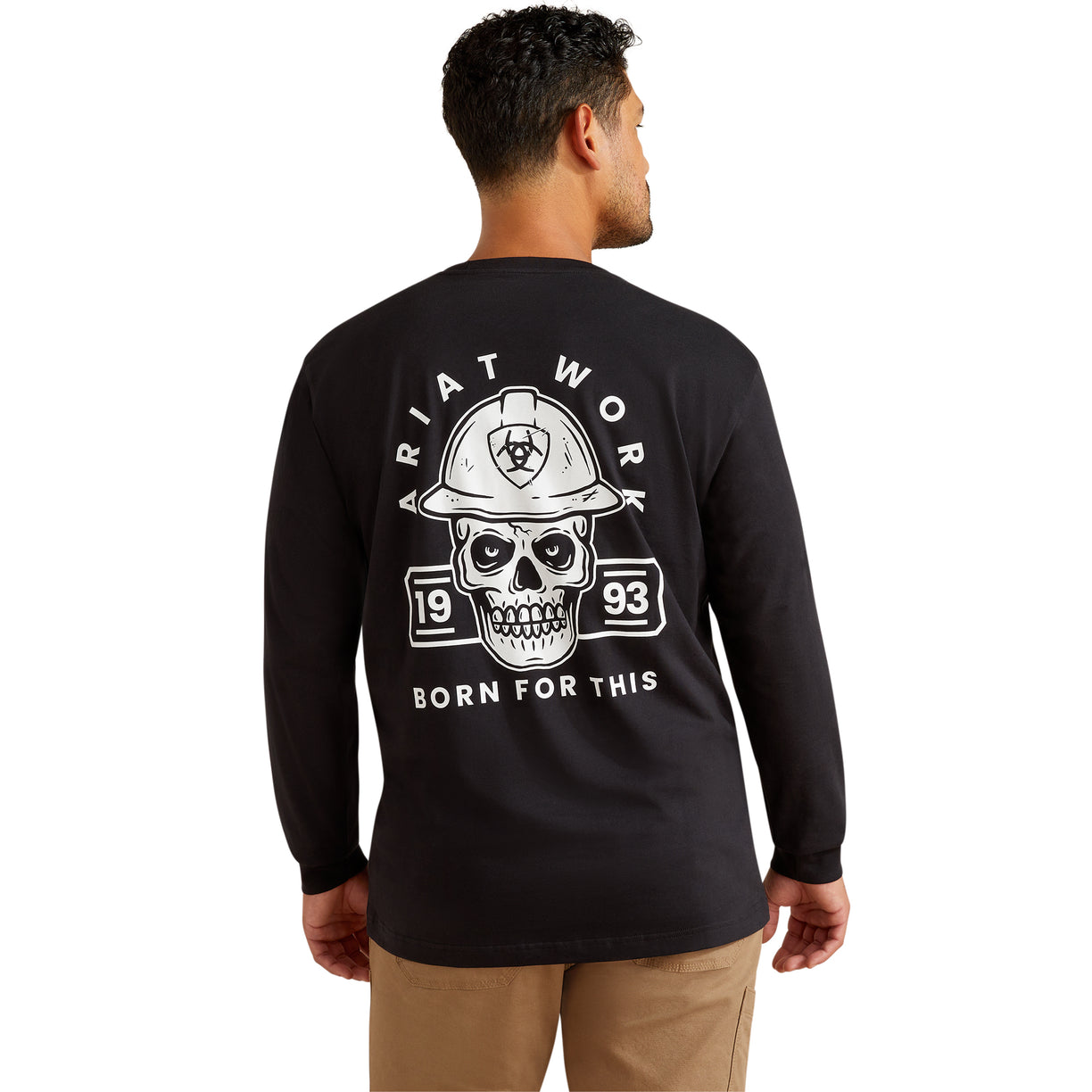 Man wearing a black long-sleeve shirt with a skull and hard hat graphic on the back.