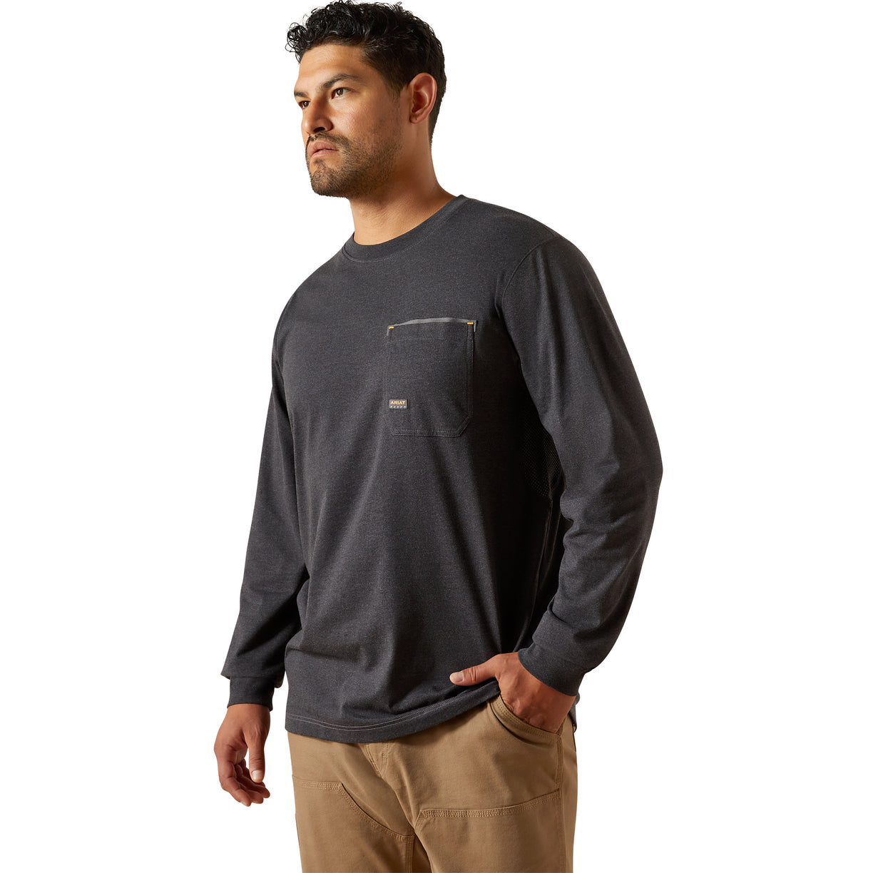 Man wearing a dark gray long-sleeve shirt with a pocket on a white background