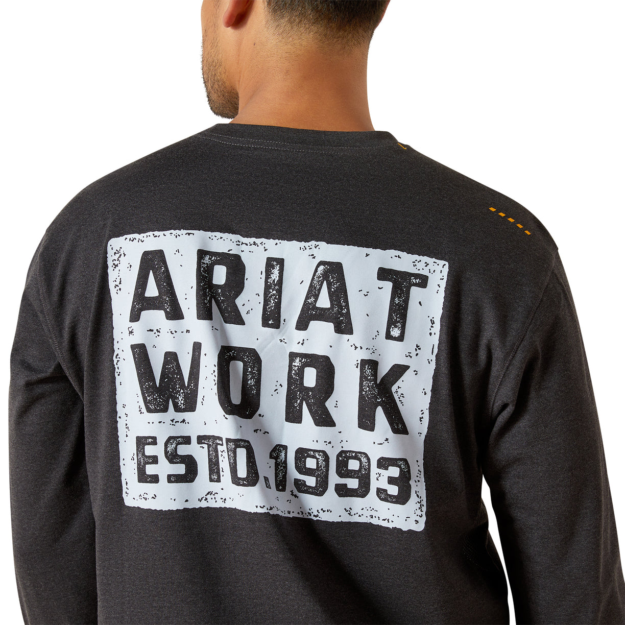 Person wearing a black long-sleeve shirt with 'Ariat Work Estd. 1993' print on the back.