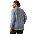Person wearing a gray long-sleeve shirt on a white background