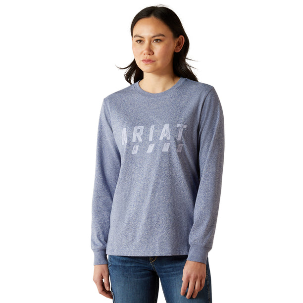 Woman wearing a blue long-sleeve shirt with a brand logo on a white background