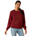 Woman wearing a maroon sweatshirt with a horse design on a white background