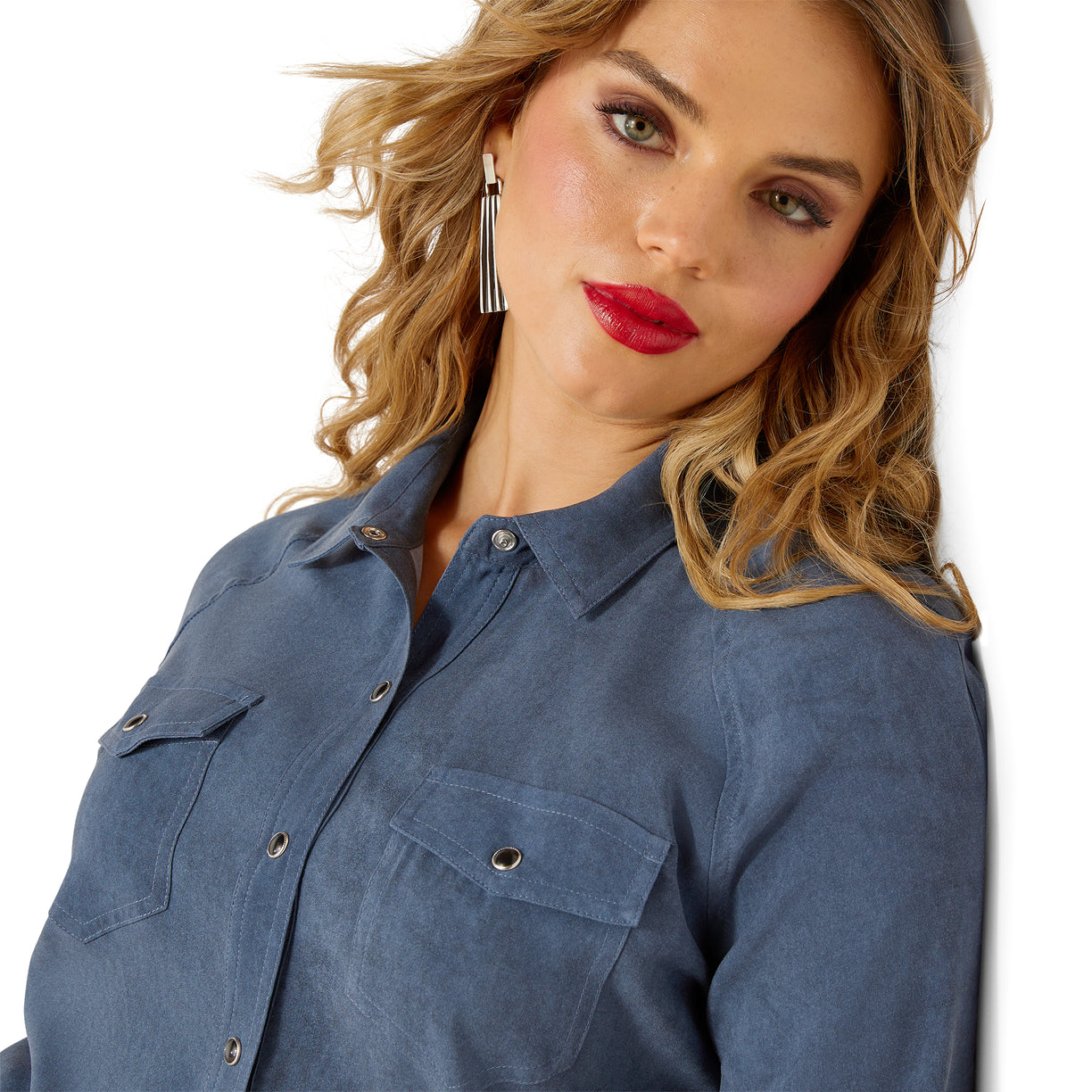 Woman wearing a blue shirt with a plain background