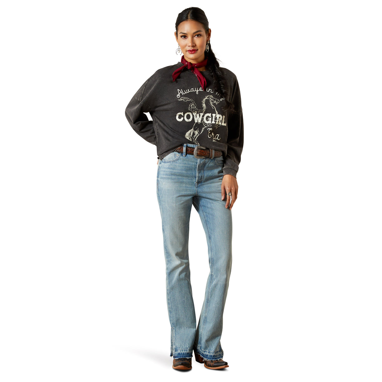 Woman wearing a black shirt with 'Always be a Cowgirl' text and blue jeans on a white background