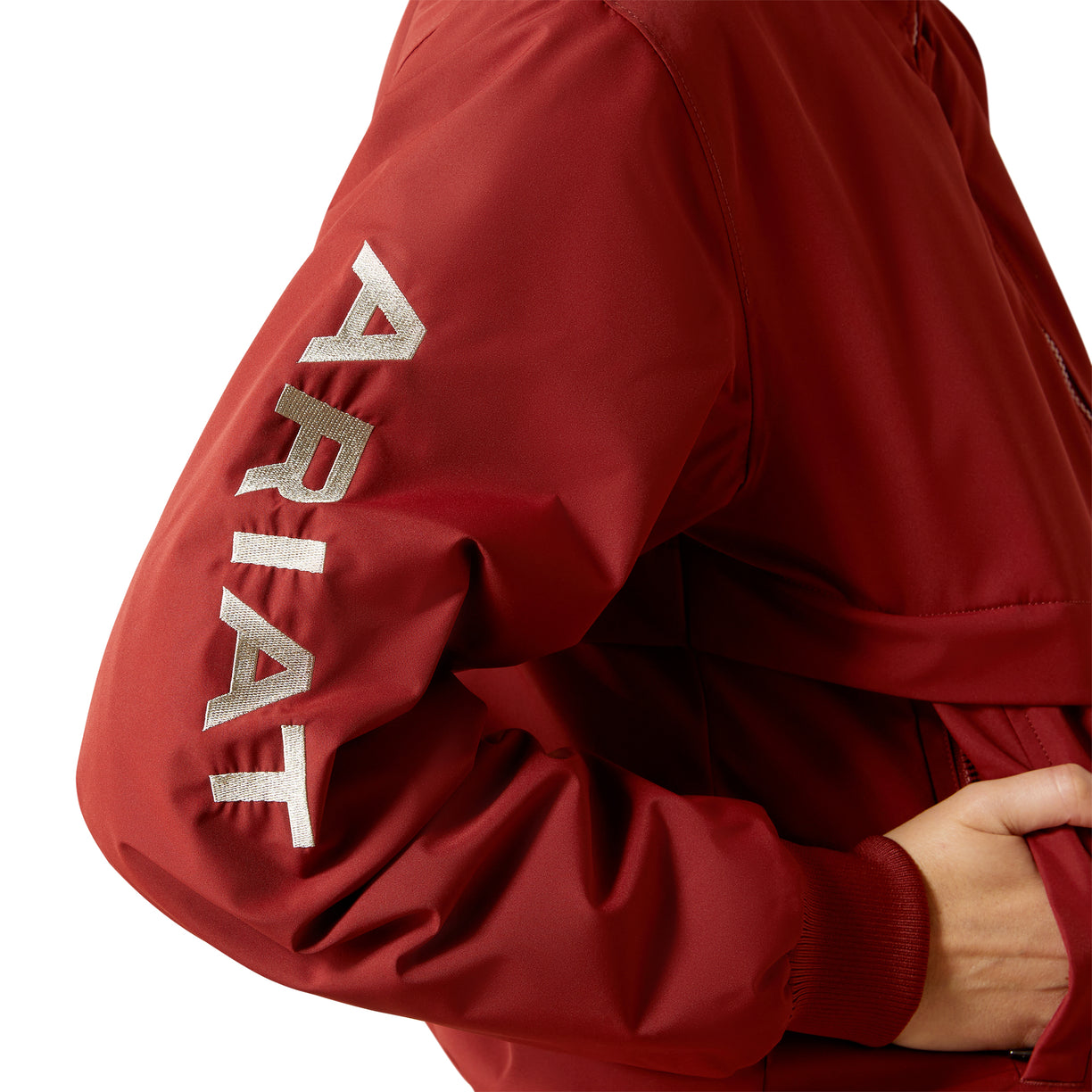 Red jacket with 'Ariat' branding on a white background