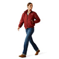 Woman wearing a red jacket with a logo on a white background