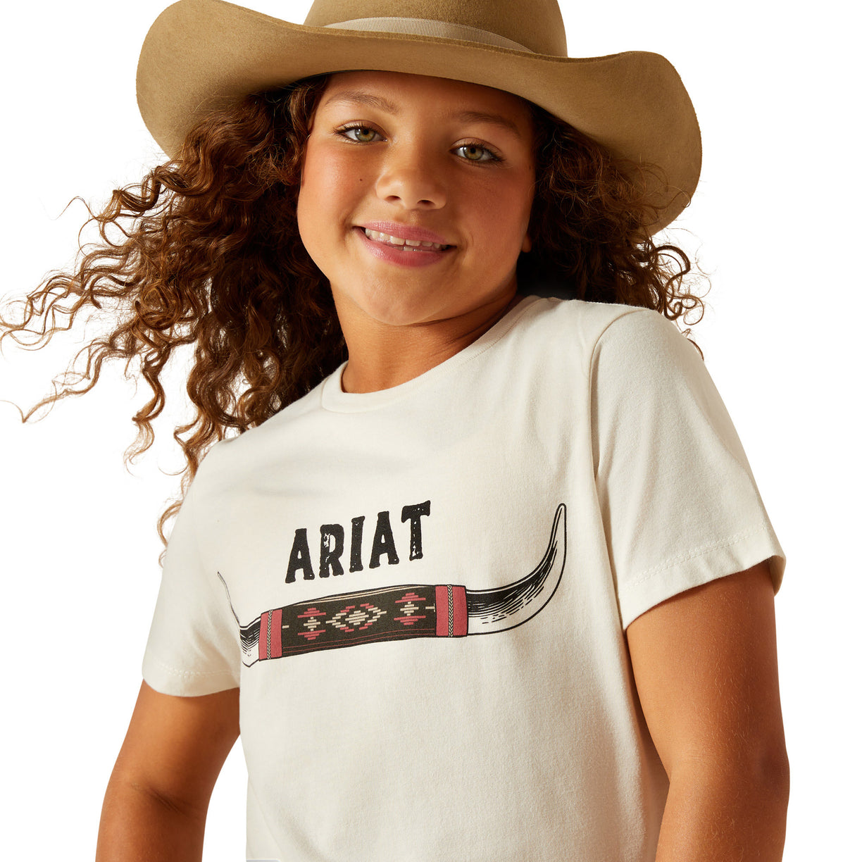 Child wearing a white t-shirt with Ariat logo and a cowboy hat on a white background