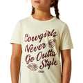 Child wearing a t-shirt with 'Cowgirls Never Go Outta Style' text and roses.