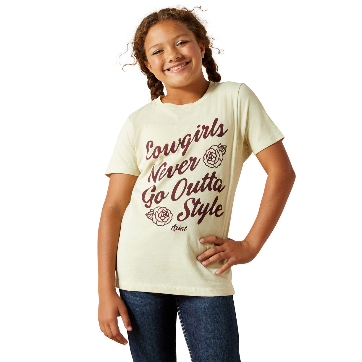 Young girl wearing a cream t-shirt with text and a rose graphic on a white background
