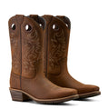 Pair of brown cowboy boots with intricate designs on a white background