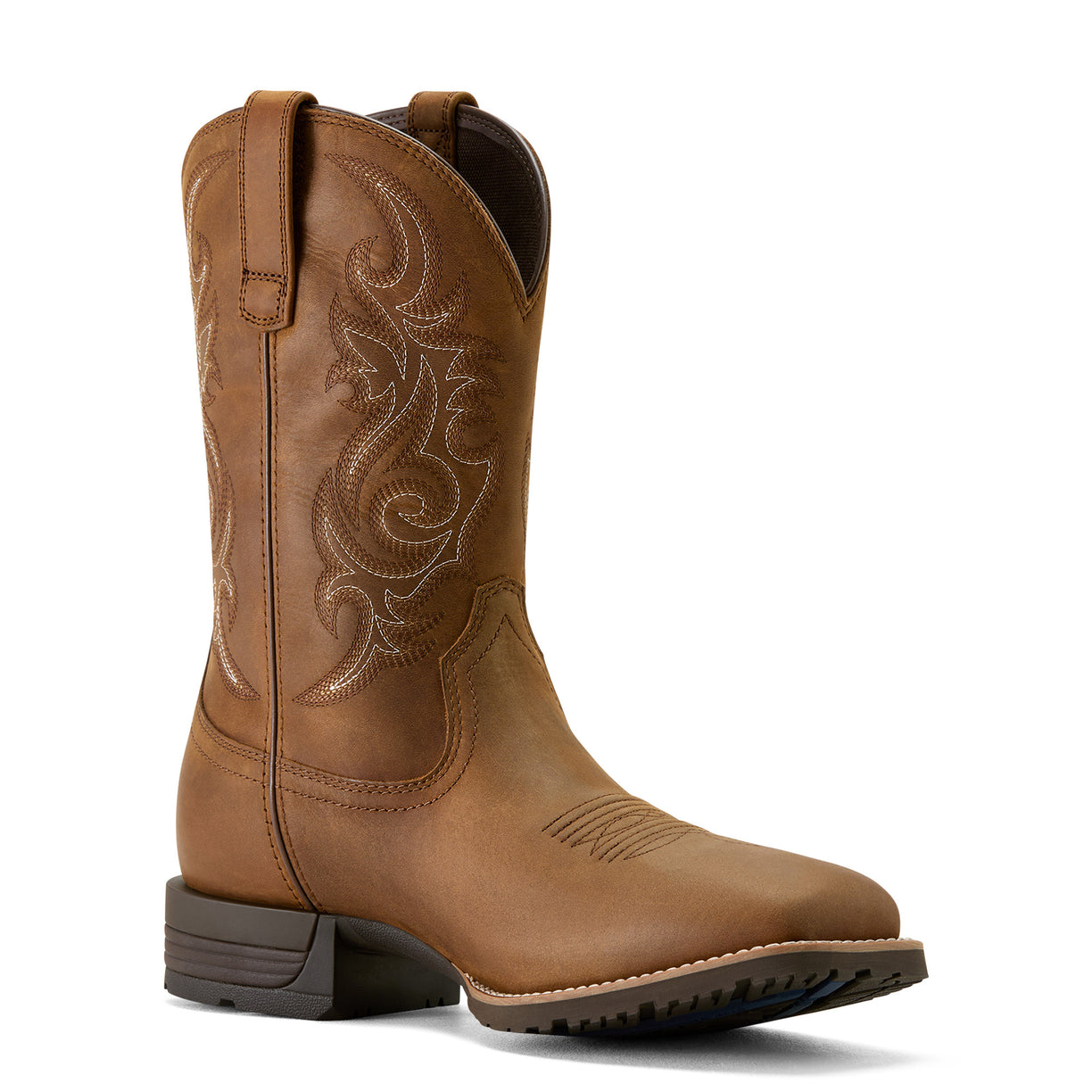 Brown cowboy boot with intricate embossing on a white background