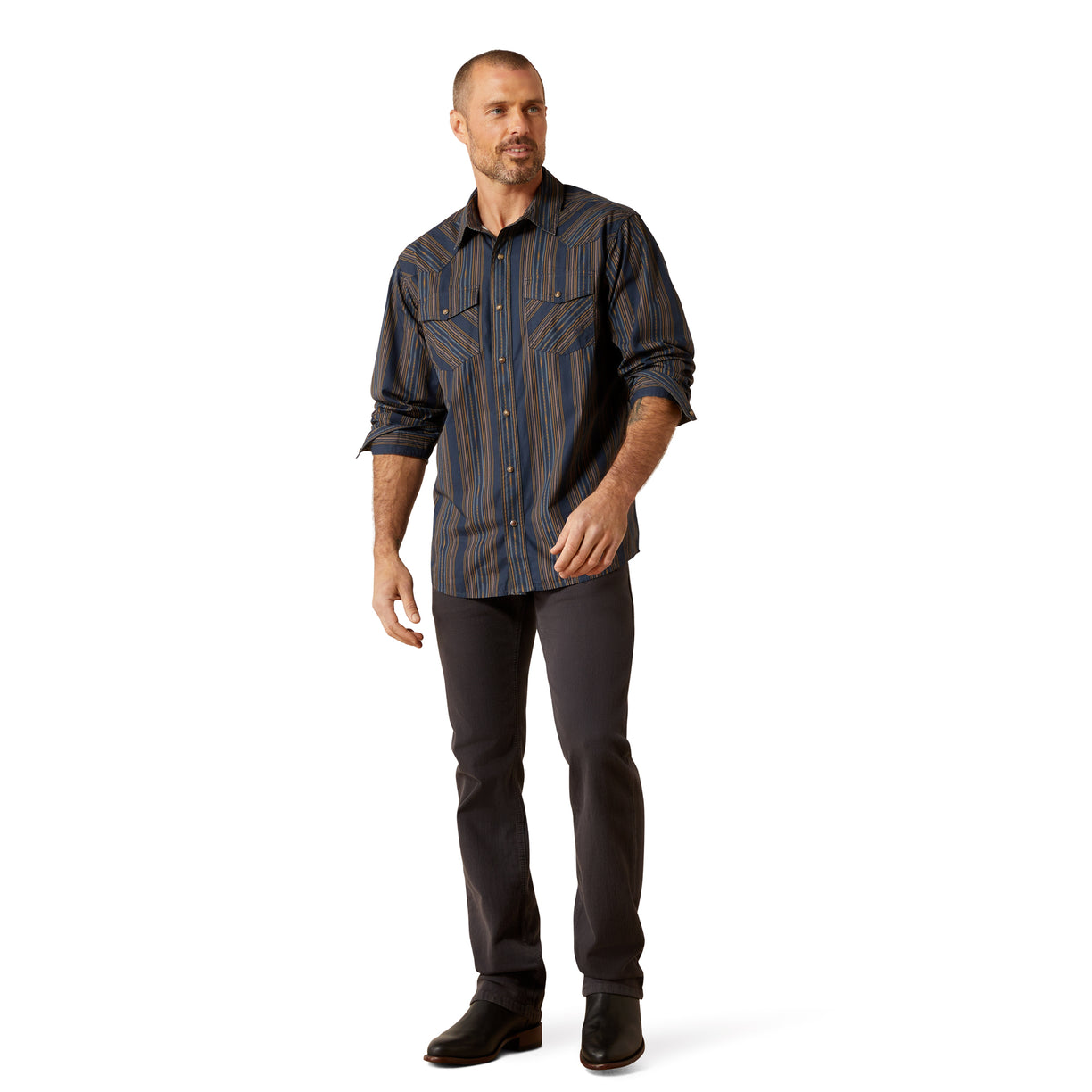 Man wearing a patterned shirt and dark pants on a white background