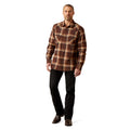 Man wearing a brown plaid shirt and black pants on a white background