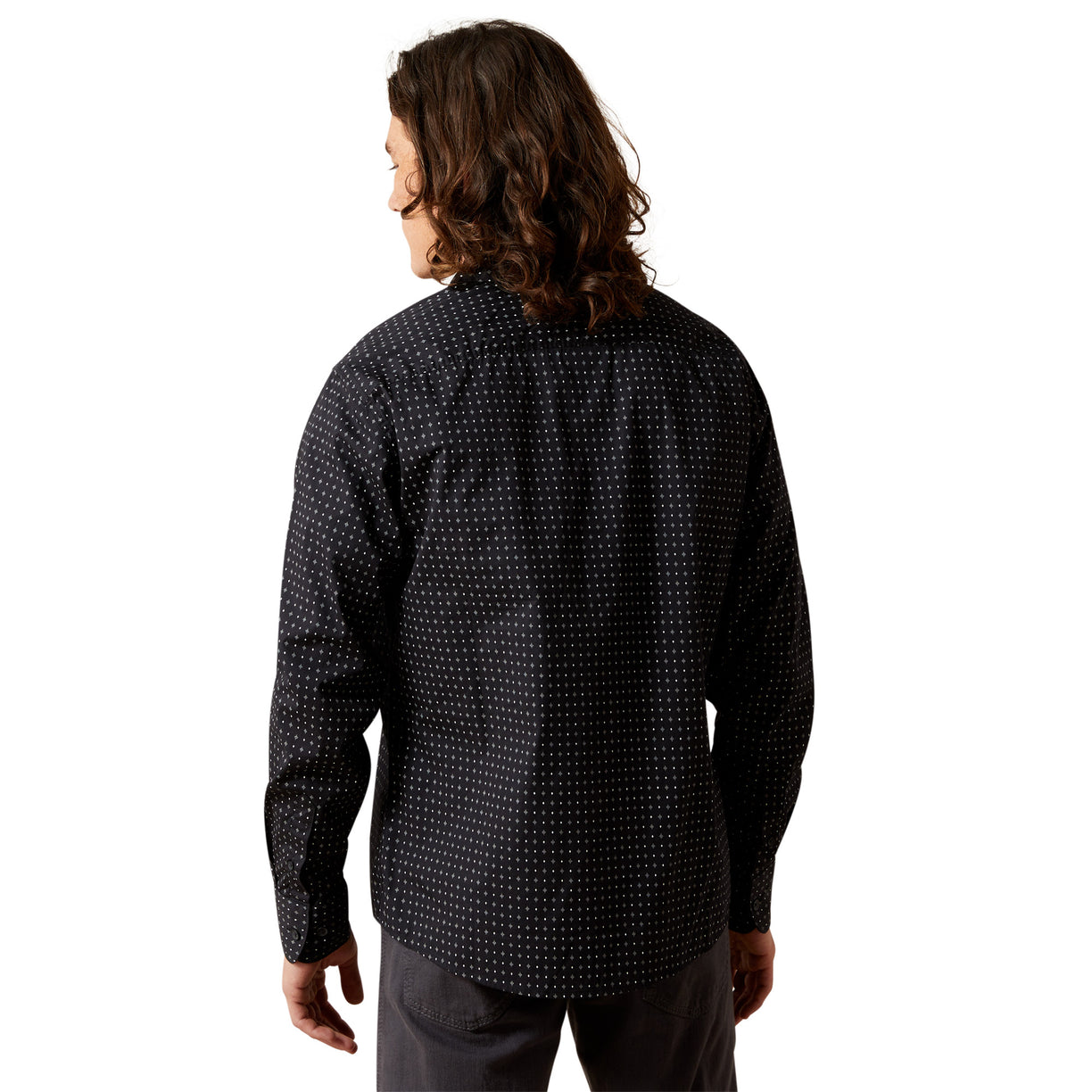 Person wearing a black patterned shirt on a white background