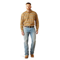 Man wearing a patterned shirt and jeans on a white background