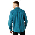 Man wearing a teal patterned shirt on a white background