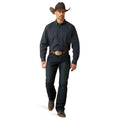 Man wearing a plaid shirt, jeans, and a cowboy hat on a white background