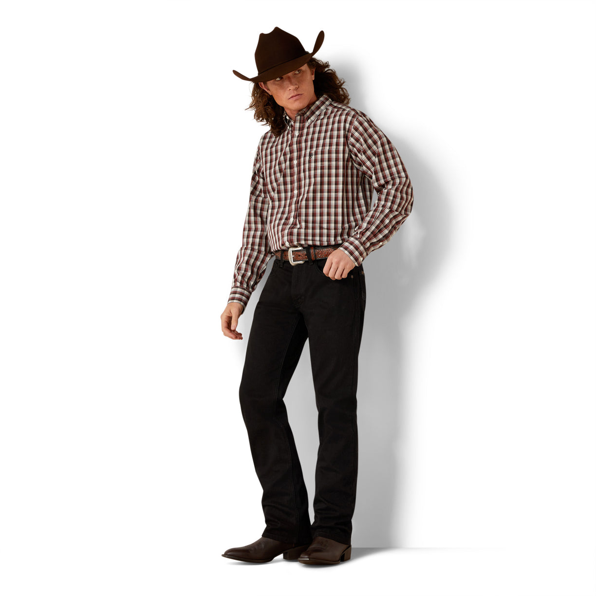 Person wearing a plaid shirt, black pants, and a cowboy hat on a white background