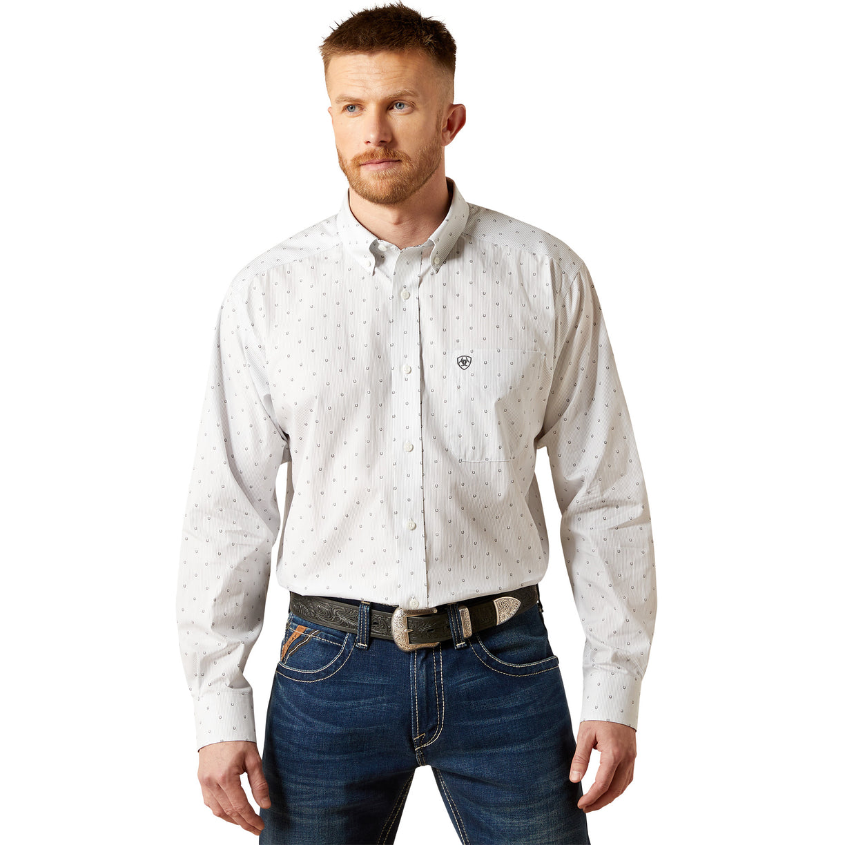 Man wearing a light gray patterned shirt and blue jeans on a white background