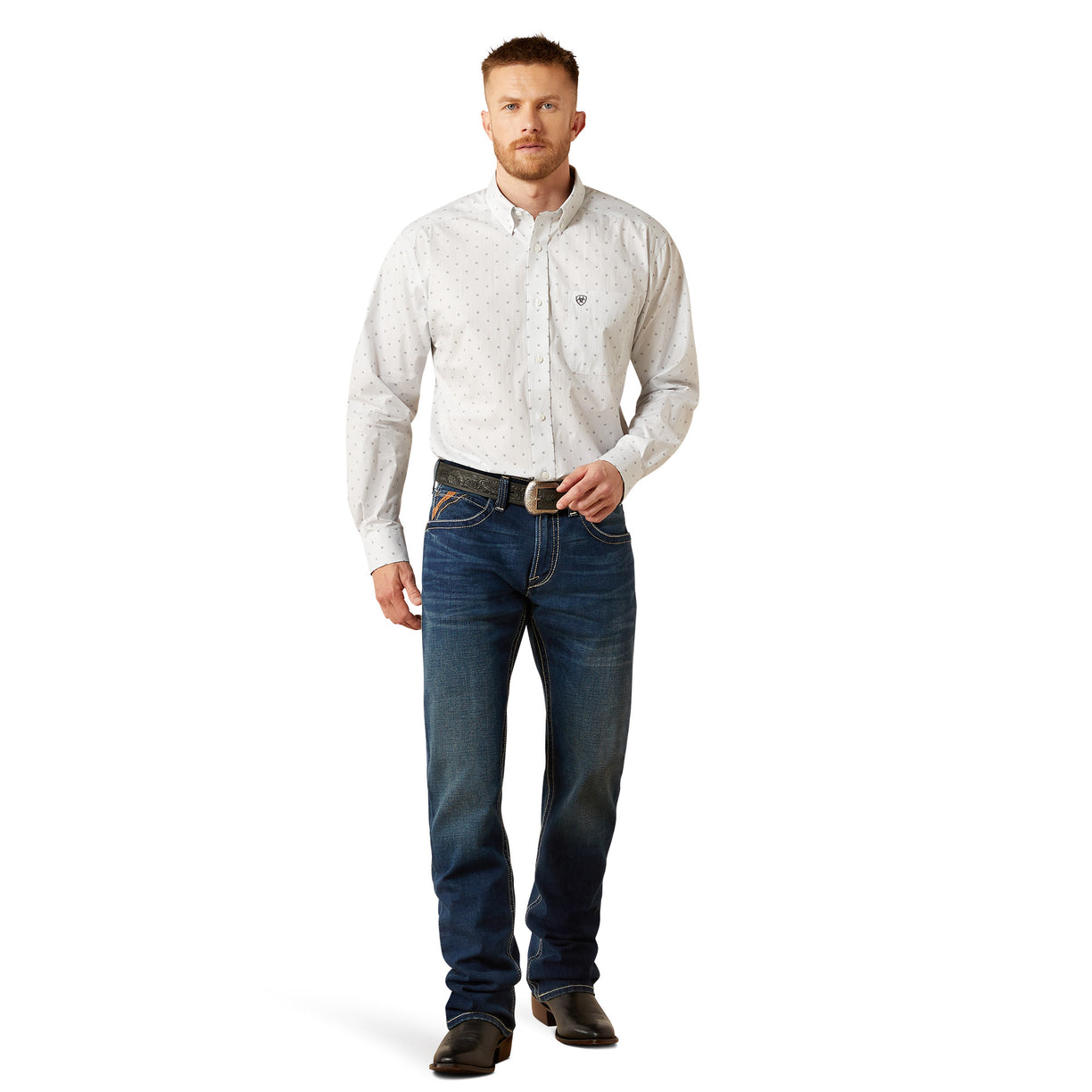 Man wearing a light-colored button-up shirt and dark jeans on a white background