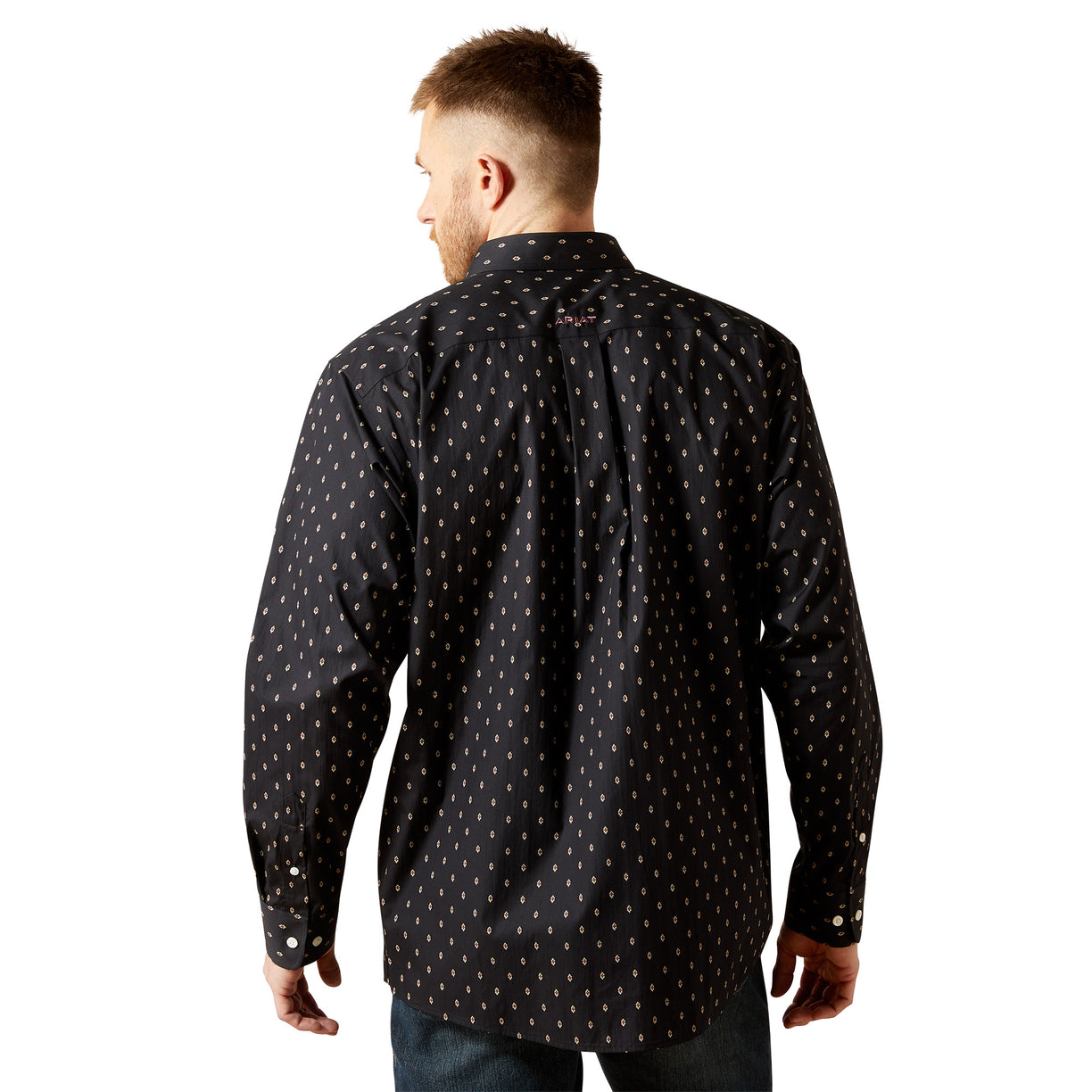 Man wearing a black patterned shirt on a white background