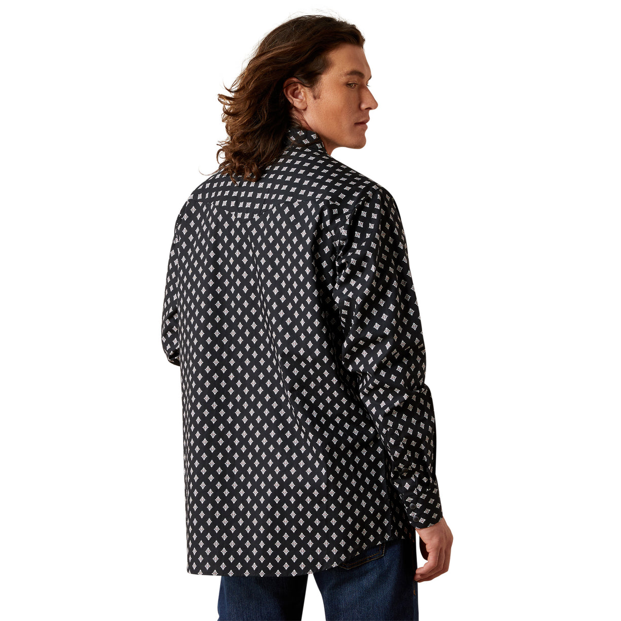 Man wearing a black and white patterned shirt on a white background