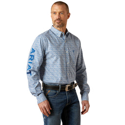 Man wearing a blue patterned Ariat shirt on a white background
