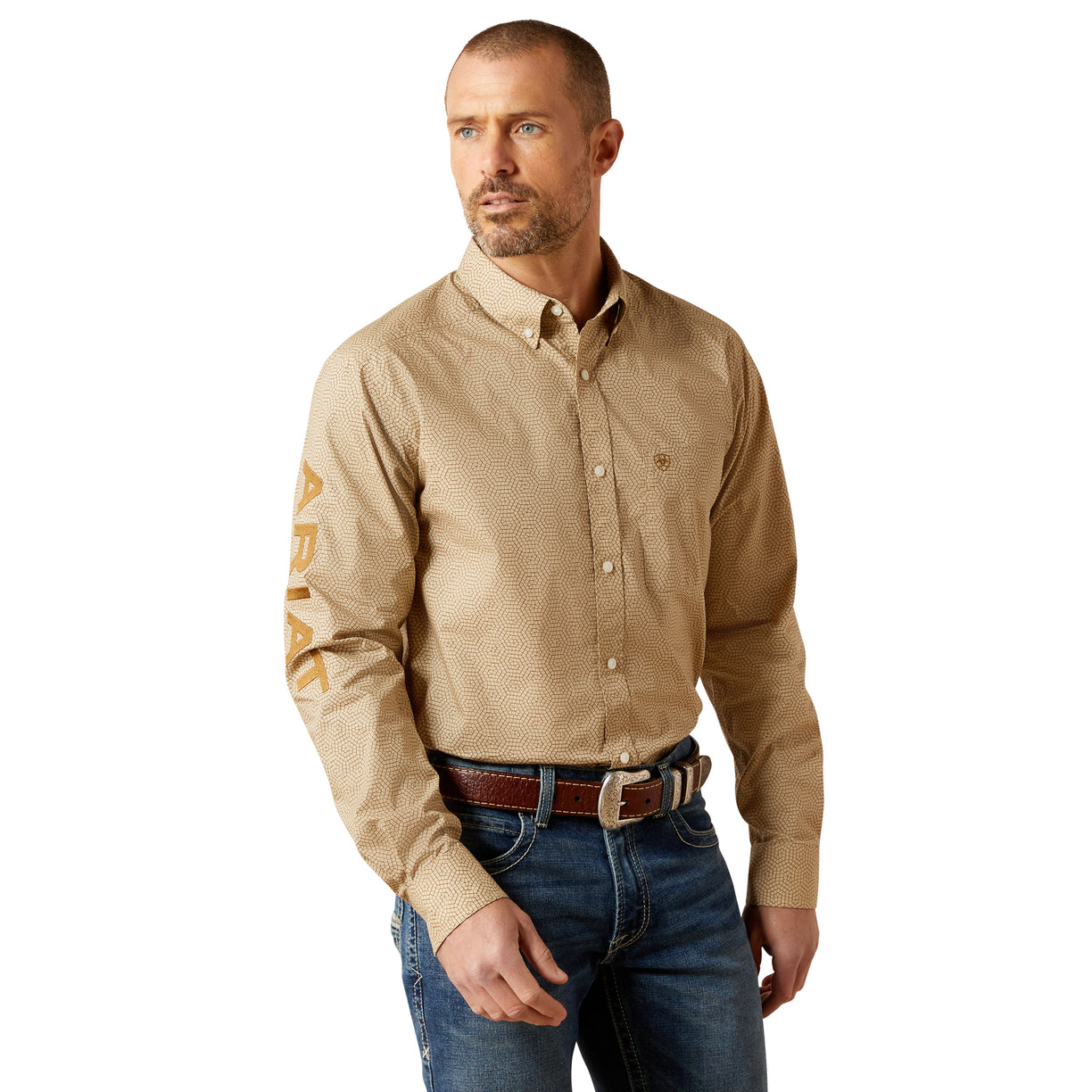 Man wearing a beige patterned shirt and blue jeans on a white background