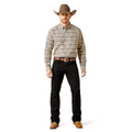 Man wearing a patterned shirt, black pants, and a cowboy hat on a white background