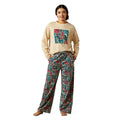 Woman wearing a beige sweatshirt with colorful graphic and patterned pants on a white background
