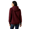 Person wearing a maroon hoodie on a white background