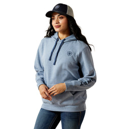 Woman wearing a light blue hoodie and cap on a white background