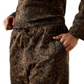 Camouflage pants worn by a person on a white background