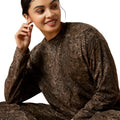 Woman wearing a brown patterned outfit on a white background