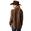 Woman wearing a brown patterned shirt and cowboy hat on a white background